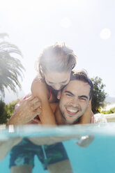 Couple playing in swimming pool - CAIF03315