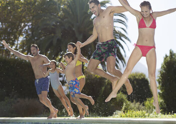 Family jumping into swimming pool - CAIF03356