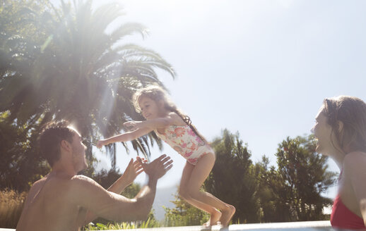 Family playing in swimming pool - CAIF03359