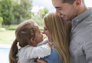 Mother and daughter touching noses outdoors - CAIF03413