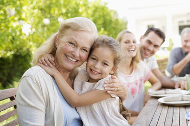 Older woman and granddaughter smiling outdoors - CAIF03415