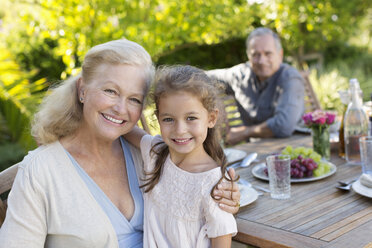 Older woman and granddaughter smiling outdoors - CAIF03416