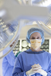 Surgeon standing in operating room - CAIF03427