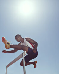 Track and field athlete clearing hurdle - CAIF03727