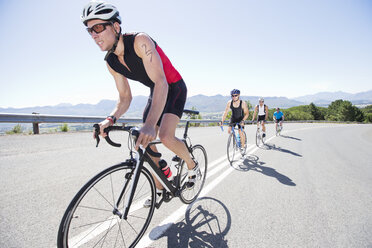 Cyclists in race on rural road - CAIF03859