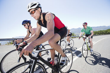 Cyclists in race on rural road - CAIF03862