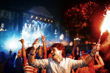 Fans with fireworks at music festival - CAIF03986