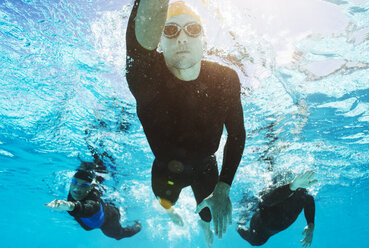 Triathletes in wetsuits underwater - CAIF04065