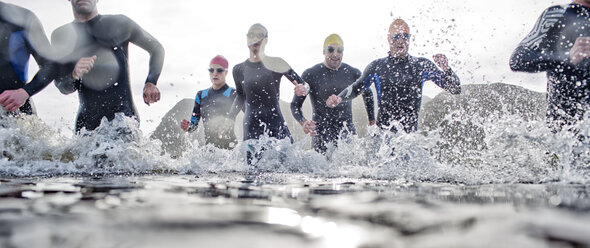 Triathletes emerging from water - CAIF04086