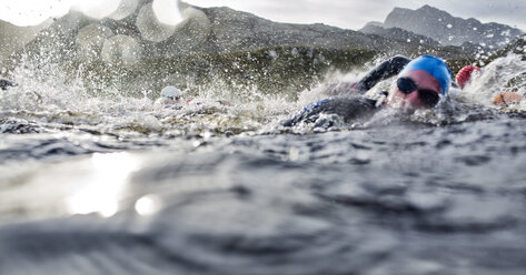 Swimmers splashing in water - CAIF04098