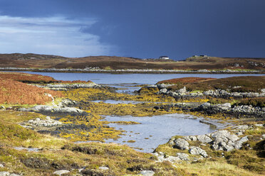 Sunny tranquil view craggy rocks and lake, Loch Euphoirt, North Uist, Outer Hebrides - CAIF04146