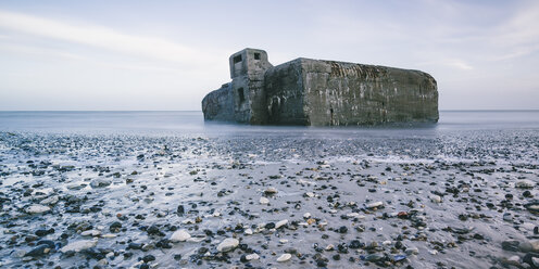 Ruins in ocean at low tide and rocks on beach, Vigsoe, Denmark - CAIF04158