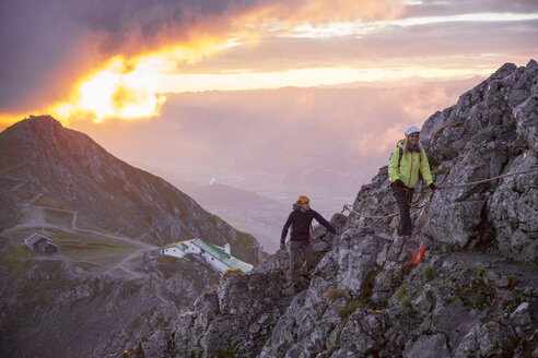 Austria, Tyrol, Innsbruck, mountaineer at Nordkette via ferrata at sunrise - CVF00244