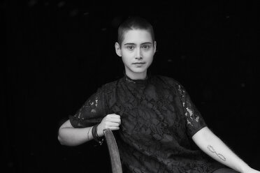 Portrait of sitting short-haired young woman - FMKF04884