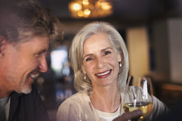 Portrait smiling senior couple drinking white wine in bar - HOXF00001