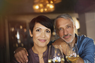 Portrait confident couple drinking white wine in bar - HOXF00013