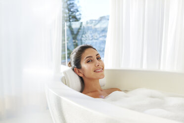 Portrait smiling woman relaxing enjoying bubble bath - HOXF00113