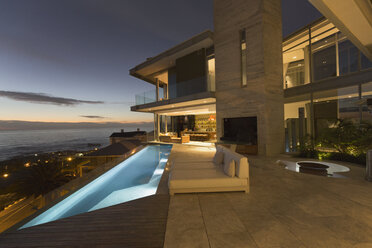 Illuminated luxury home showcase exterior and infinity lap pool with ocean view - HOXF00132