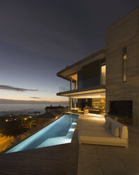 Illuminated home showcase exterior patio with lap pool and ocean view - HOXF00165