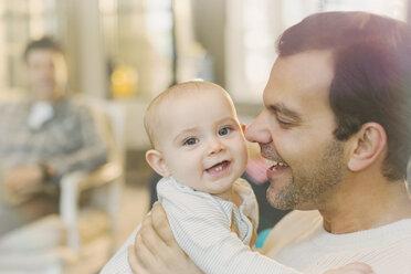 Portrait happy father holding cute baby son - CAIF04281