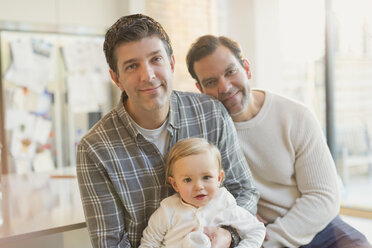 Portrait smiling male gay parents with baby son - CAIF04295