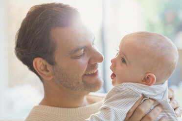 Affectionate father holding baby son - CAIF04297