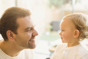 Father smiling at cute baby son - CAIF04330