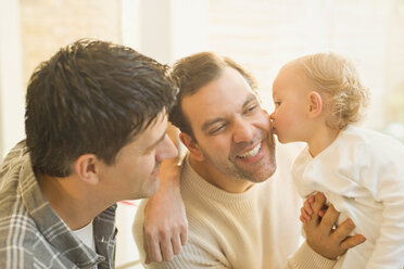 Affectionate baby son kissing male gay parents - CAIF04342