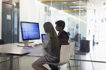 Students programming at computer in classroom - CAIF04392