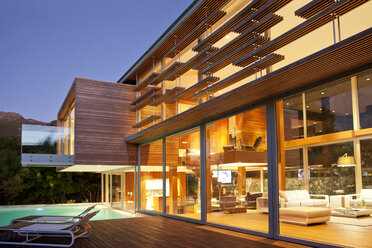 Swimming pool and modern house at night - CAIF04416