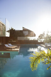 Sun shining over modern house and swimming pool - CAIF04422