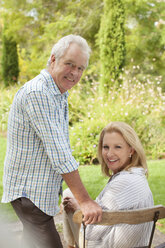 Portrait of smiling senior couple in garden - CAIF04534
