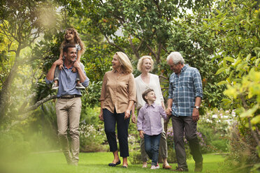 Mehrgenerationenfamilie beim gemeinsamen Spaziergang im Park - CAIF04544