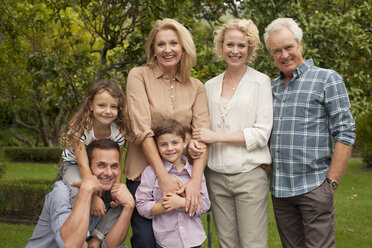 Portrait of multi-generation family smiling outdoors - CAIF04555