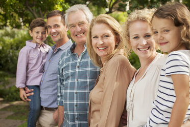 Portrait of multi-generation family smiling outdoors - CAIF04559