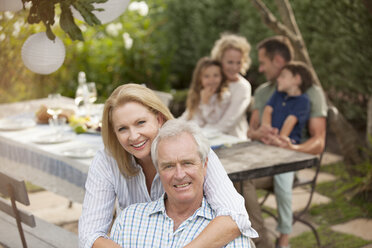 Portrait of smiling senior couple at family picnic - CAIF04562