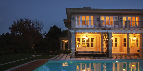 Illuminated luxury house with swimming pool at night - HOXF00209