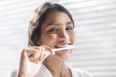 Close up portrait smiling woman brushing teeth - HOXF00295