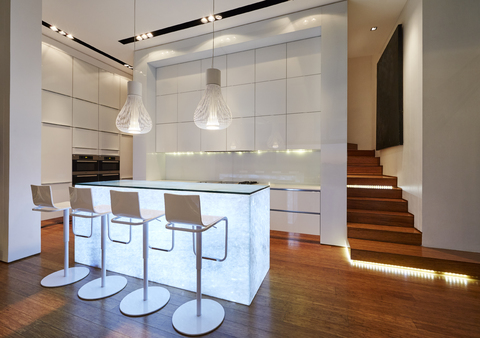Illuminated modern luxury kitchen and staircase stock photo