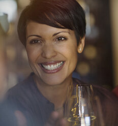 Close up portrait smiling brunette woman drinking white wine - HOXF00532