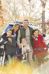 Portrait smiling family with mountain bikes outdoors - HOXF00592