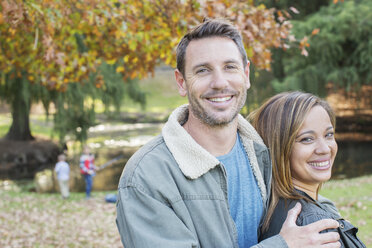 Portrait smiling couple at autumn park - HOXF00628