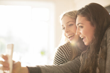 Teenage girls taking selfie with camera phone - HOXF00698