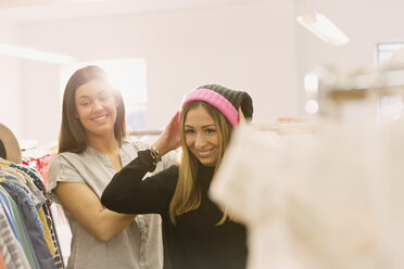 Fashion buyers trying on stocking cap - HOXF00870