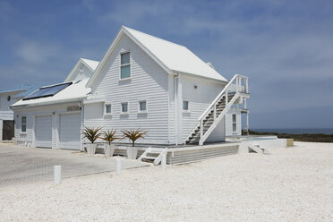 White beach house under sunny blue sky - HOXF00945