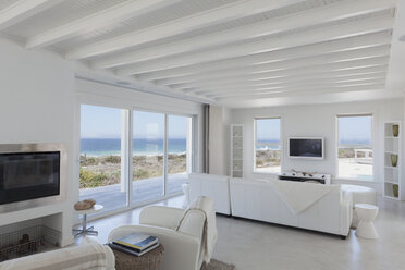 Beach house living room with wood beam ceilings - HOXF00957