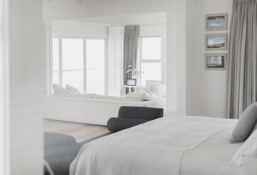 White bedroom open to living room in home showcase - HOXF00962