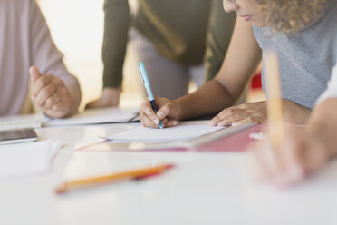 Businesswoman taking notes in meeting - HOXF01012