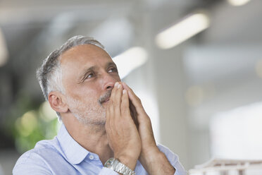 Pensive businessman looking away - HOXF01018