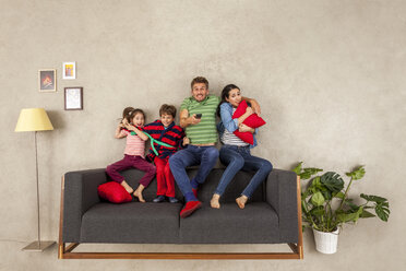 Family with two children watching TV together - BAEF01547